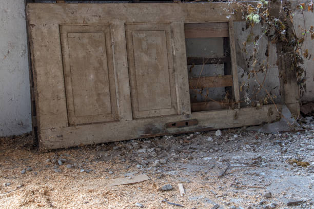 istock damaged door laying on floor 1150057448