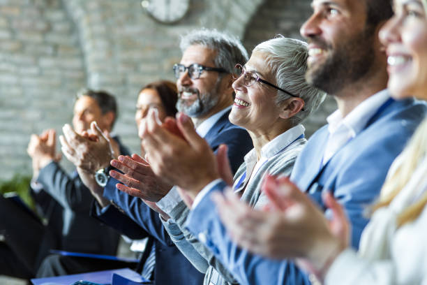 istock Happy entrepreneurs applauding on education event in board room. 1150058142