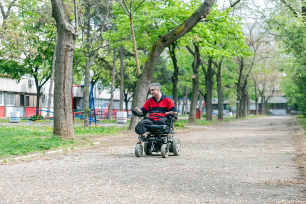 istock Disabled Man in Electric Wheelchair on the Move 1150058630