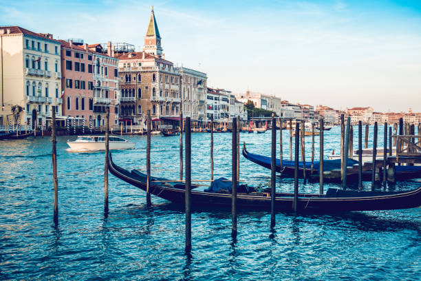 istock Old Gondolas Vs Modern Boat In Venetian  Canal 1150059909