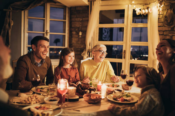 Cheerful multi-generation family talking during dinner at home.