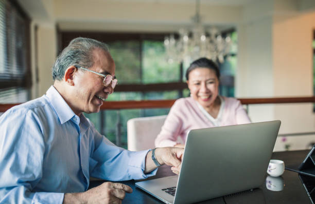 istock Modern senior couple using laptop together 1150061896