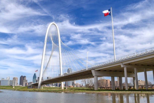 Texas State Flag Waving in the Wind on Bridge Above Trinity River - Dallas, Texas