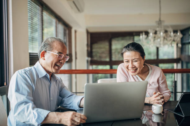 istock Modern senior couple using laptop together at home 1150063101