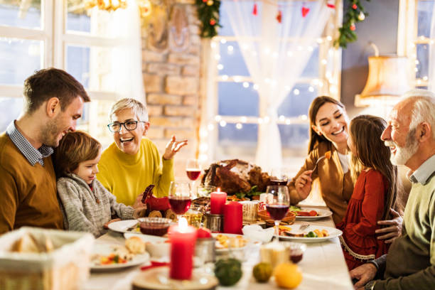 istock Happy multi-generation family enjoying in conversation during Thanksgiving lunch at dining table. 1150063302