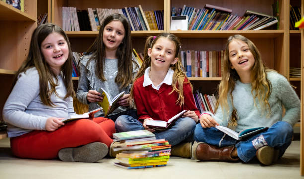 istock Group of schoolgirls in library 1150064075