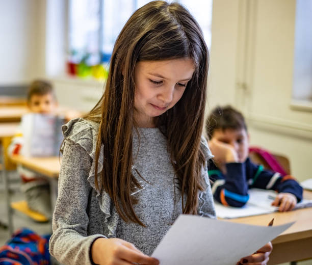 istock Schoolgirl looking test results 1150064156