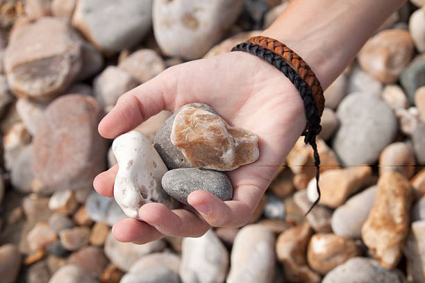 istock Girls hand holding pebbles 115006692