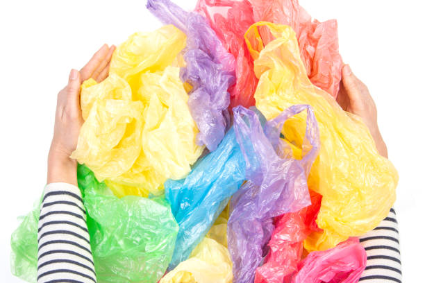 istock Woman hands holding many plastic bags over white background. No plastic, environmental, pollution concept 1150068645