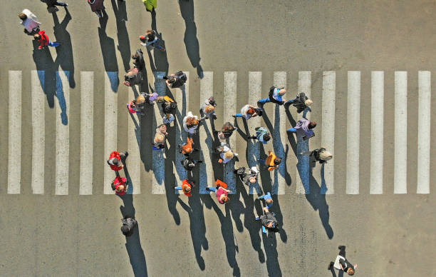 istock Crowd of people crossing a pedestrian crosswalk 1150071105