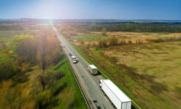 istock Transport logistics background with trucks on a highway between fields 1150072417