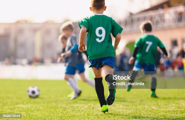 Boys Playing In A Soccer Match Stock Photo - Download Image Now - Child, Soccer, Sport
