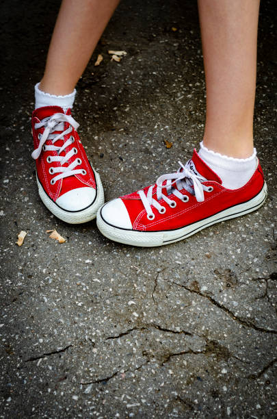 istock Legs in red sneakers 1150073991