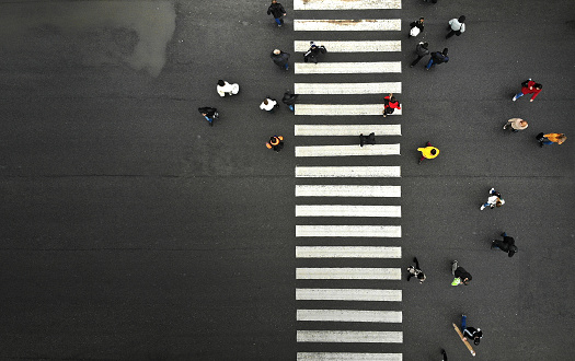 Aerial. Urban lifestyle background with people on pedestrian crosswalk. Top view.