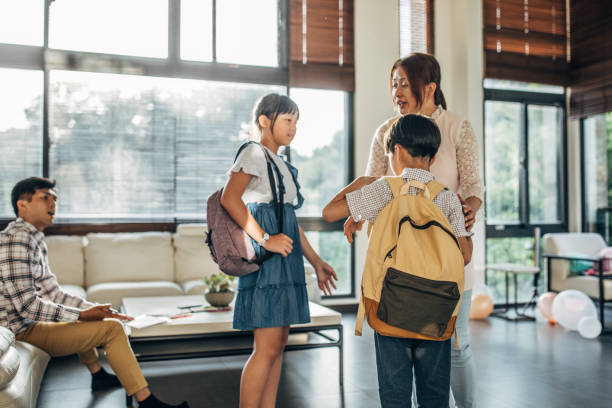 istock Parents sending daughter and son to school 1150076627