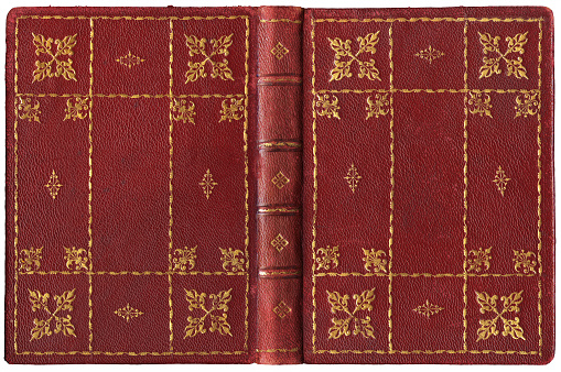 Old open book in textured red leather cover with floral and abstract embossed golden decorations, isolated on white, nice details, XL size