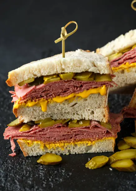 Photo of New York pastrami, gherkins and sourdough bread deli sandwich