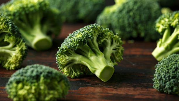 istock Healthy Green Broccoli on rustic wooden table. 1150078335