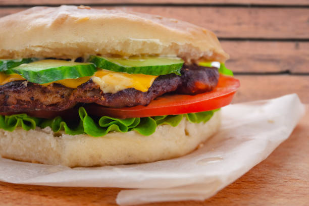istock fresh flavored cheeseburger with juicy cutlet, cucumbers, tomato and lettuce 1150081397