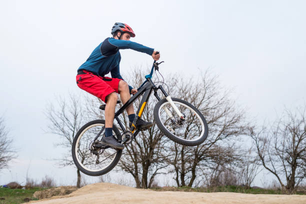 istock Man on a mountain bike performing a dirt jump. 1150082804
