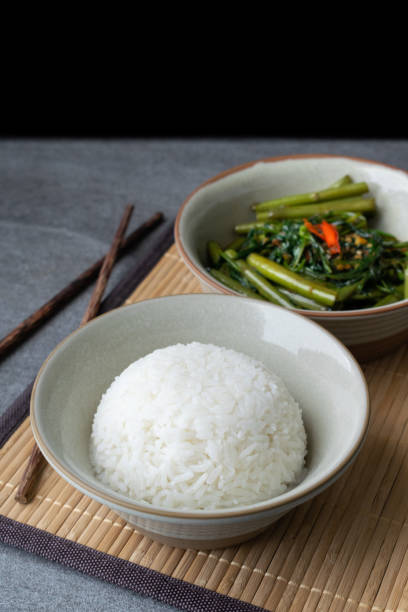 istock Fried morning glory with rice in gray bowl on table. 1150087694