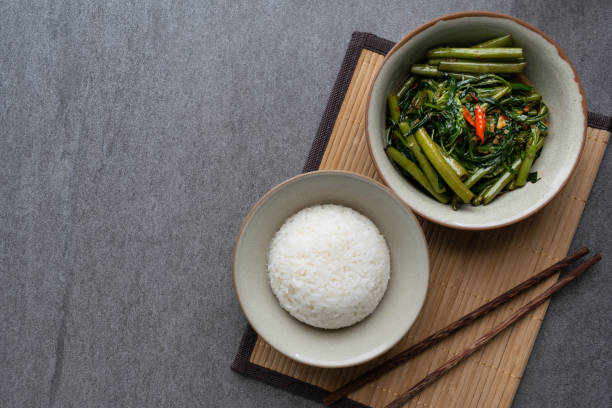 istock Fried morning glory with rice in gray bowl on table. 1150087697