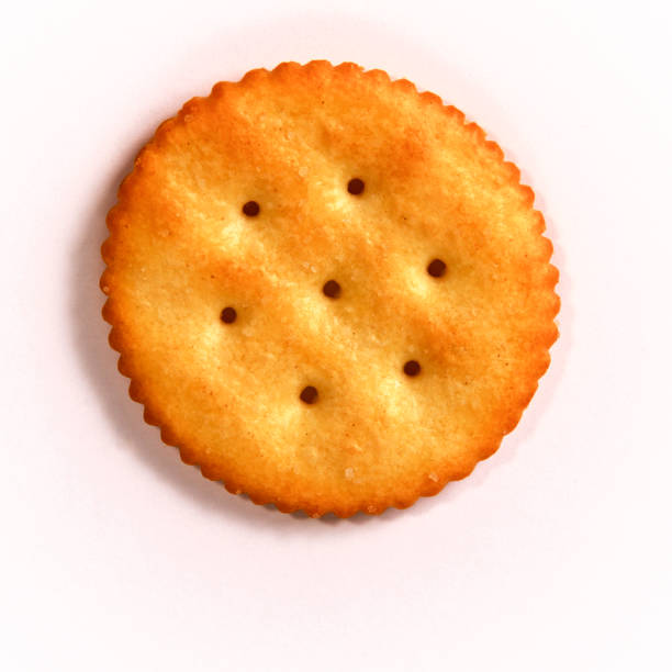 istock one golden round butter cracker over white 1150090997