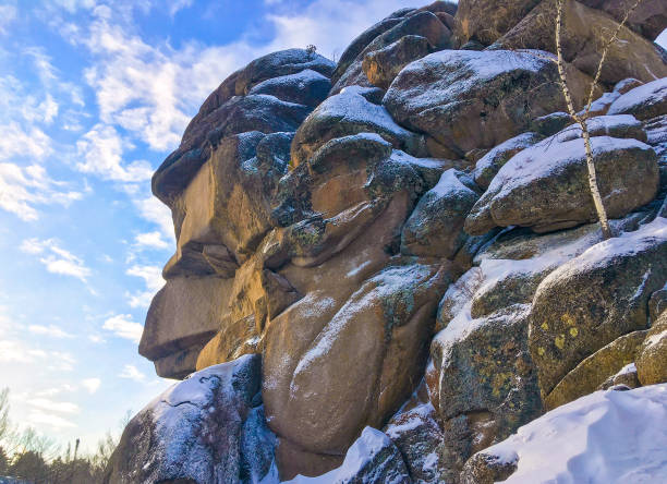 Rock natural pillar called the Grandfather or Ded in the Stolby Nature Sanctuary, Russia, Siberia, near the city of Krasnoyarsk. Awesome background in winter Siberian taiga.