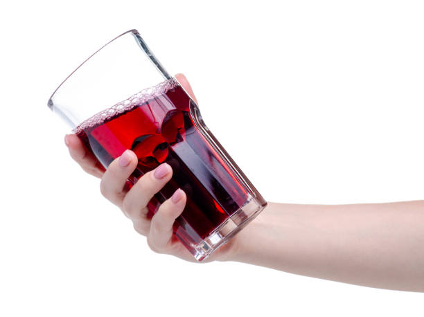 istock Cherry juice in a glass in hand 1150091651