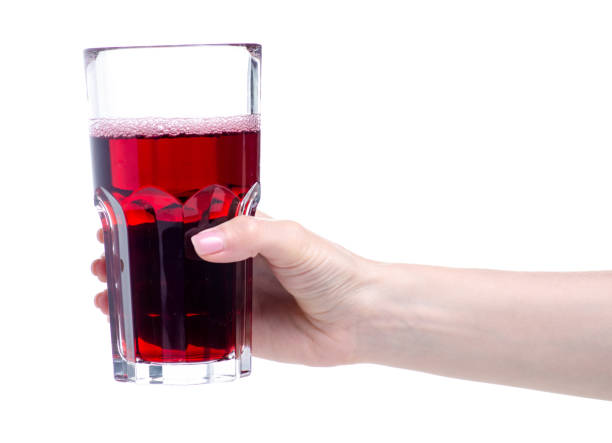 istock Cherry juice in a glass in hand 1150091663
