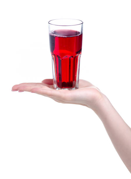 istock Cherry juice in a glass in hand 1150091677