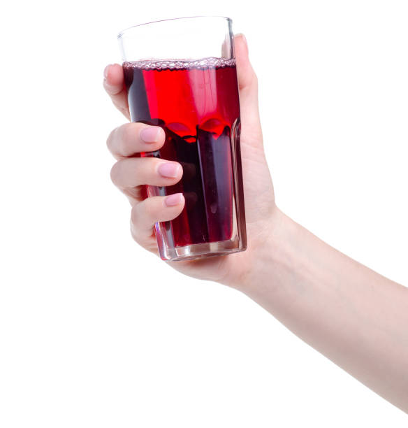 istock Cherry juice in a glass in hand 1150091754