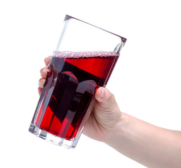 istock Cherry juice in a glass in hand 1150092068