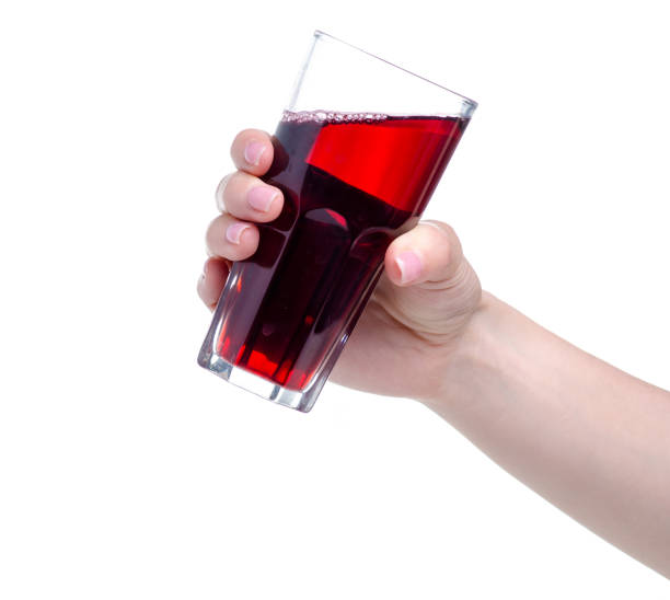 istock Cherry juice in a glass in hand 1150092274