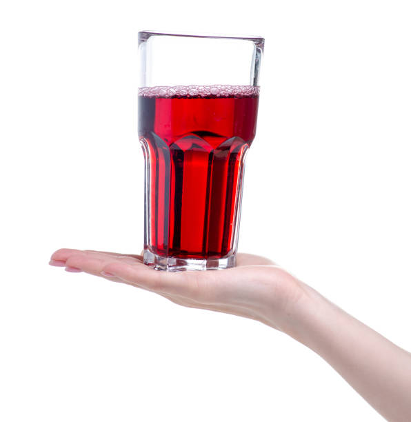 istock Cherry juice in a glass in hand 1150092314