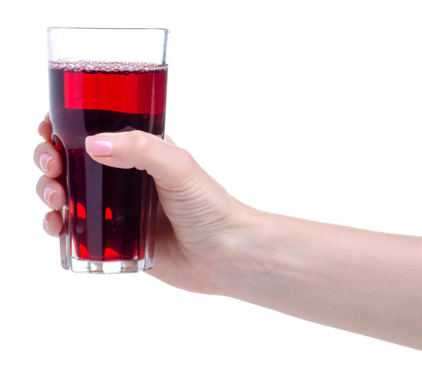 istock Cherry juice in a glass in hand 1150092326