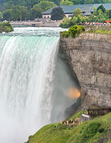 Niagara Falls, Canada - August 14, 2022: People having fun on a tourboat at the Niagara Falls in Canada
