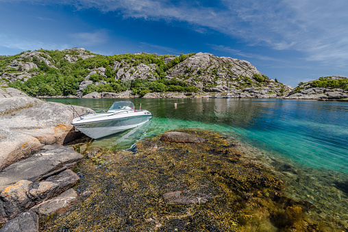 Spangereid, Norway - June 21 2017:a power boat at a beautiful bay one fantastic summer day in southern Norway.