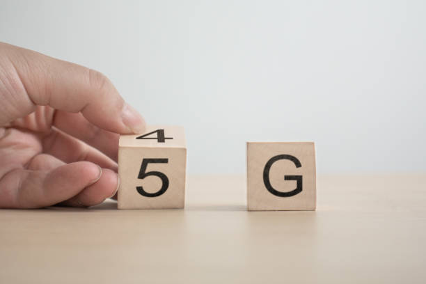 istock 5G (5th Generation) network connecting technology future global. Hand flip wood cube change number 4G to 5G 1150095644