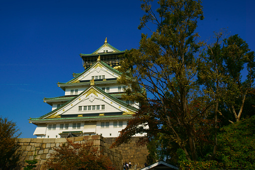 Osaka, Japan -November  8, 2018:  There is a beautiful city garden in the center of Osaka, which is a must-see for every visitor to Osaka. The Osaka Castle Castle Tower stands in the middle of the city and is an irreplaceable symbol of Osaka.