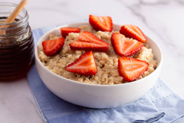istock Oatmeal with Strawberries on a Marble Table 1150097155