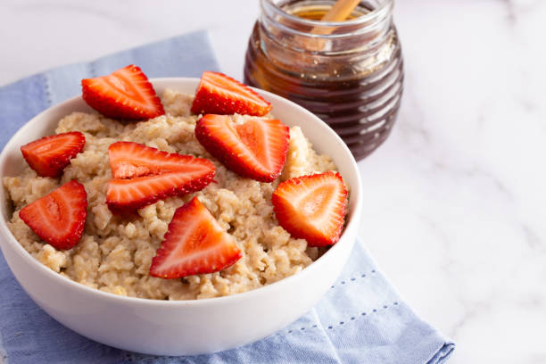 istock Oatmeal with Strawberries on a Marble Table 1150097165