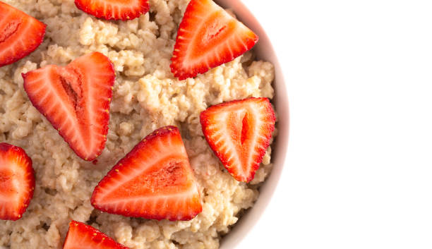 istock Oatmeal with Strawberries Isolated on a White Background 1150097322