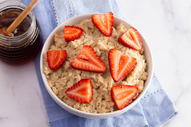 istock Oatmeal with Strawberries on a Marble Table 1150097333