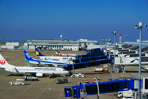 Nagoya, Japan -November  11, 2018:  Airplanes parked at Chubu Centrair International Airport in Nagoya, Japan. This airport is opened on February 17, 2005. It is 5th international airport in Japan. Many workers working at airport area.\