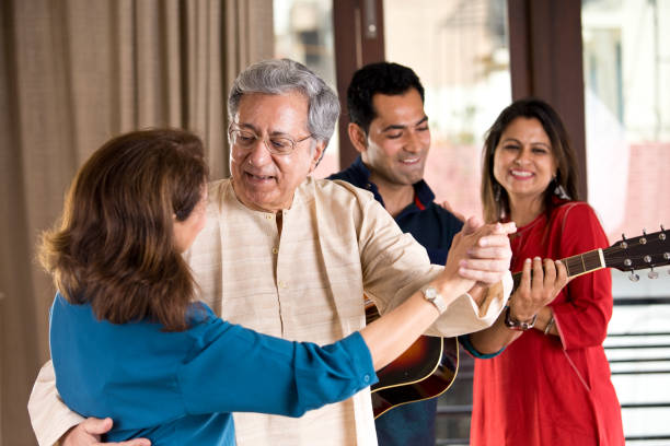 Family playing guitar and dancing at home Happy Indian family playing guitar and dancing at home father and son guitar stock pictures, royalty-free photos & images