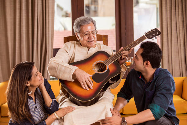 Family with guitar at home Happy Indian family with guitar at home father and son guitar stock pictures, royalty-free photos & images