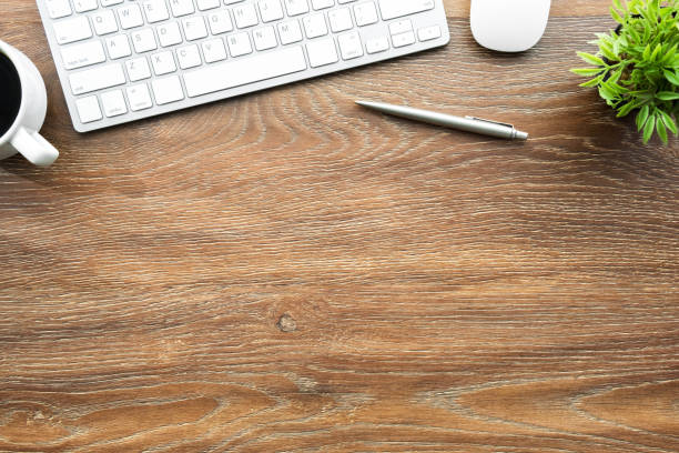 istock Wood office desk table with computer keyboard, mouse and supplies. Top view with copy space, flat lay. 1150098700