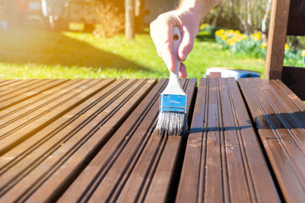 Copy space.  Painter paints the surface of a wooden board with a brush. Protection of wooden materials from rotting and water. Summer day and sun rays. House painter paints the surface of a wooden board with a brush. Protection of wooden materials from rotting and water. Summer day and sun rays.
Copy space deck stock pictures, royalty-free photos & images