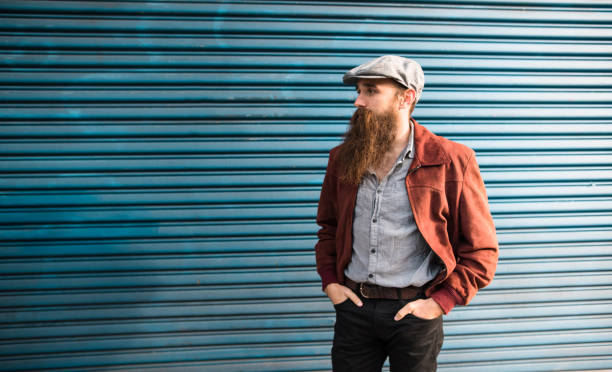 istock hipster portrait with arm crossed against the wall 1150106986